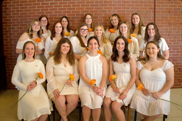 photo of women in white dresses with an coral rose
